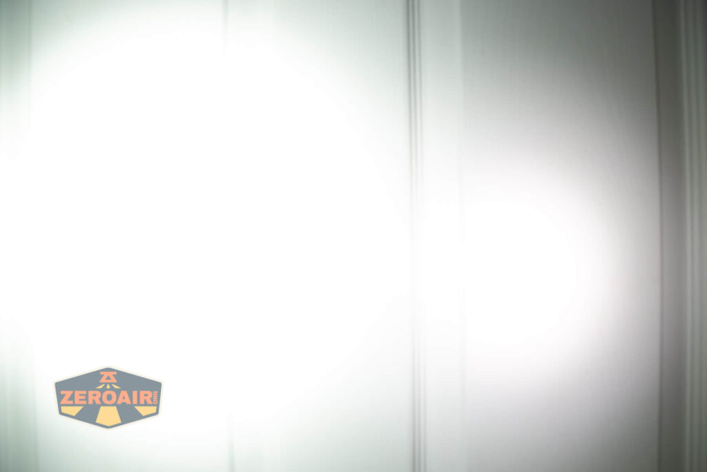 Sofirn SR20 Mini EDC flashlight beamshots on door (at 1') compared to nichia 219b 4500K