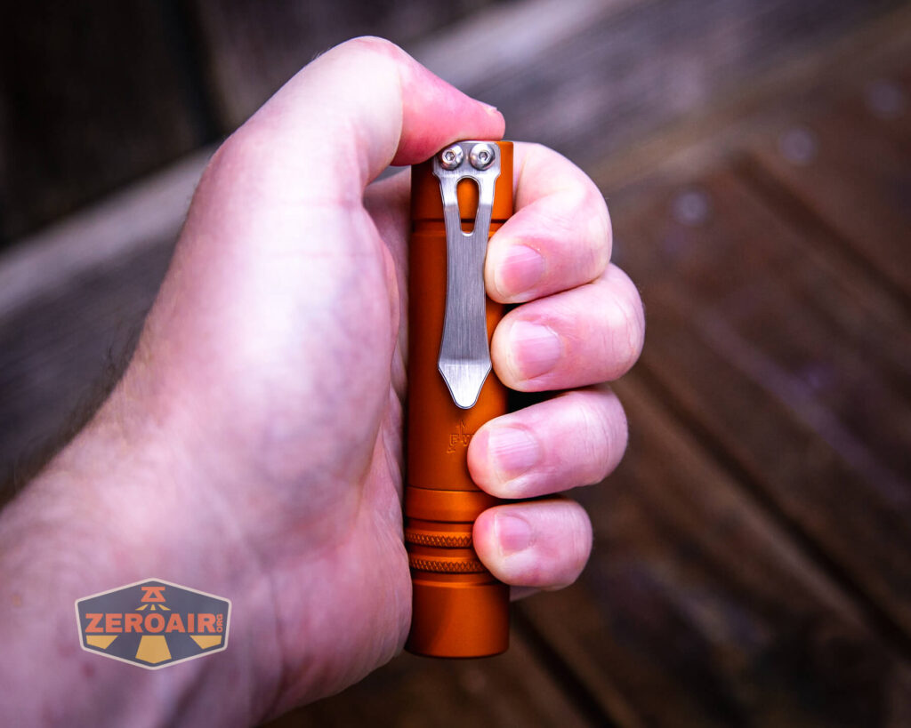 Focusworks EDC F3 Pumpkin Orange flashlight in hand