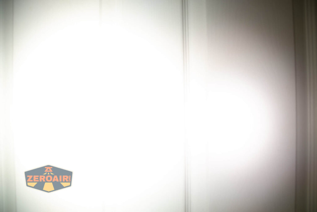 Focusworks EDC F3 Pumpkin Orange flashlight beamshots on door (at 1') compared to nichia 219b 4500K