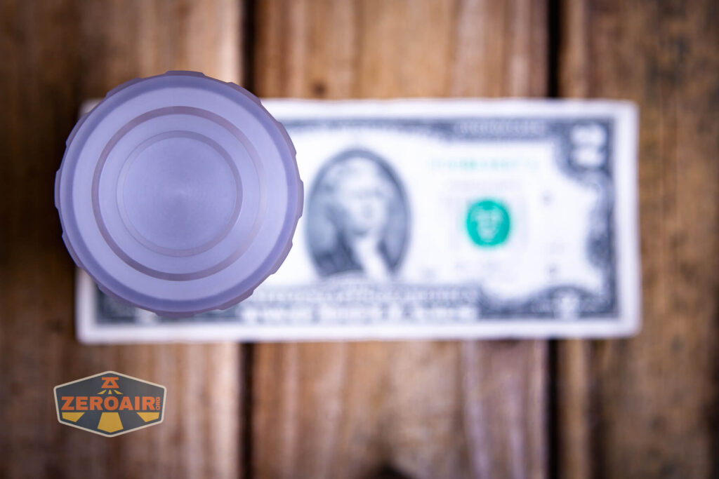 Lumintop Aurora flashlight powerbank on a two dollar bill