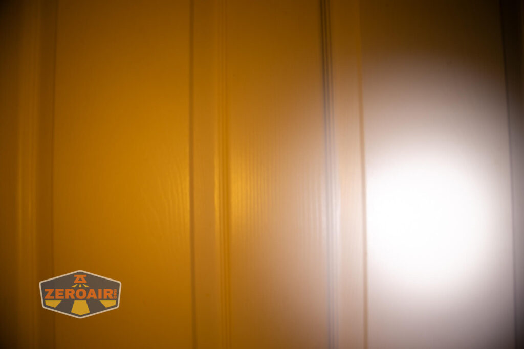 Lumintop Aurora flashlight powerbank beamshots on door (at 1') compared to nichia 219b 4500K