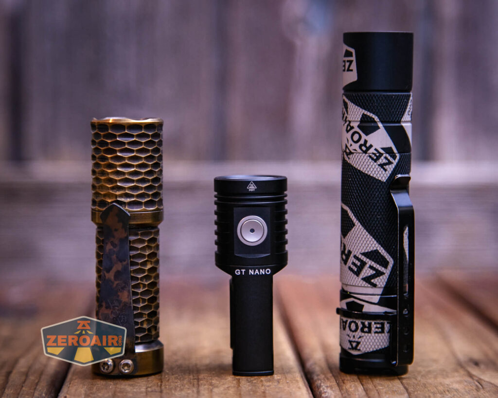 Lumintop GT Nano V5.0 flashlight with two standard sized flashlights