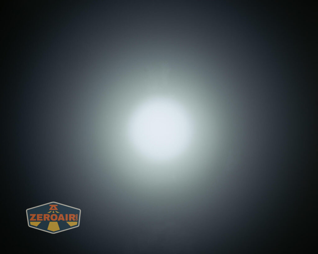 A bright white circular light is shown in the center against a dark background, with a ZeroAir logo in the bottom left corner.