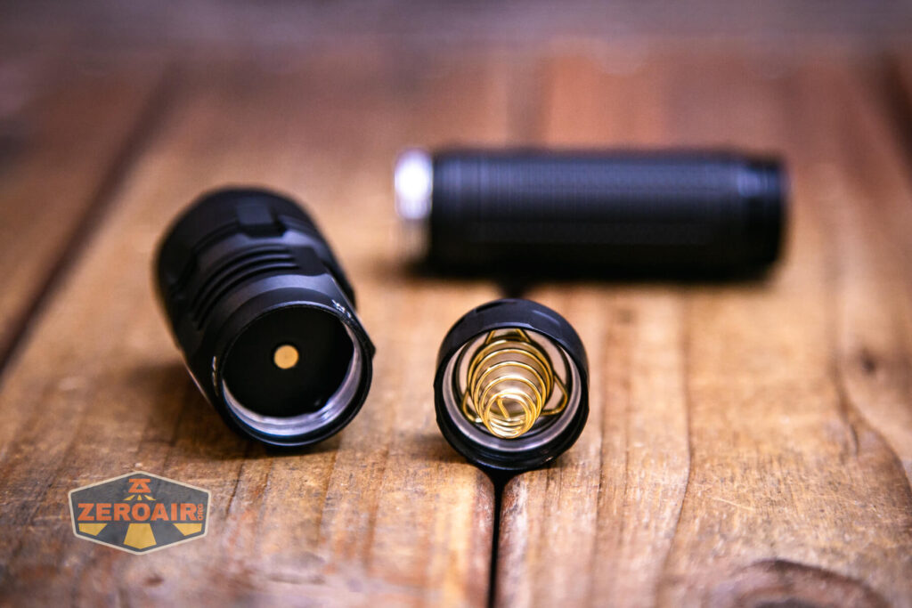 Lumintop W1 LED flashlight showing spring and head contact