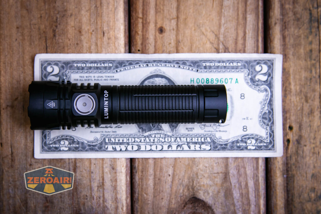 Lumintop W1 flashlight on two dollar bill