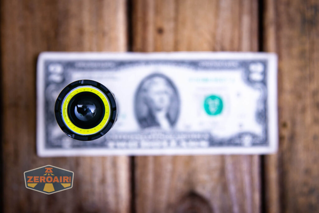 Lumintop W1 flashlight on two dollar bill