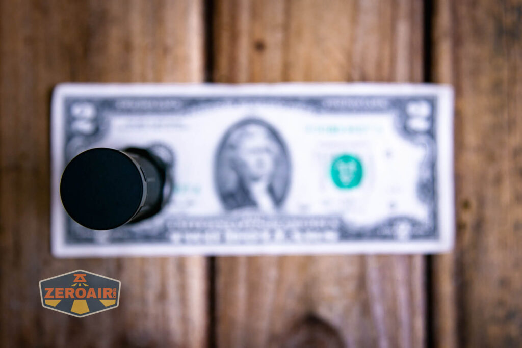 Lumintop W1 flashlight on two dollar bill