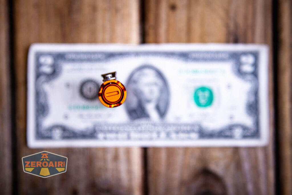 ReyLight Pineapple Mini Mk II flashlight on a two dollar bill