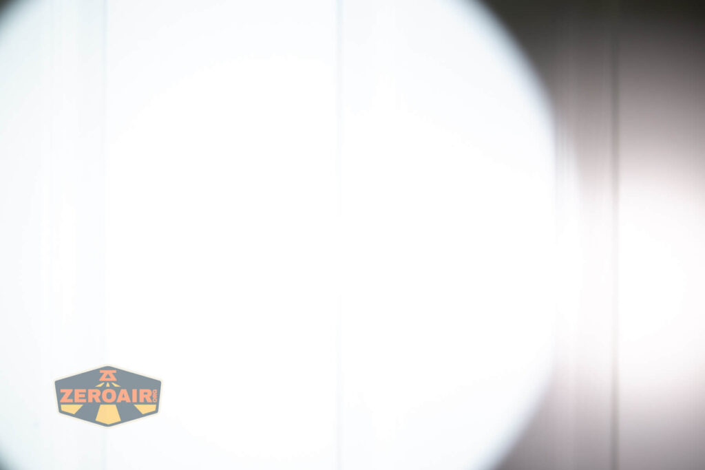 Weltool T12 Plus Nine Dragons flashlight beamshots on door (at 1') compared to nichia 219b 4500K