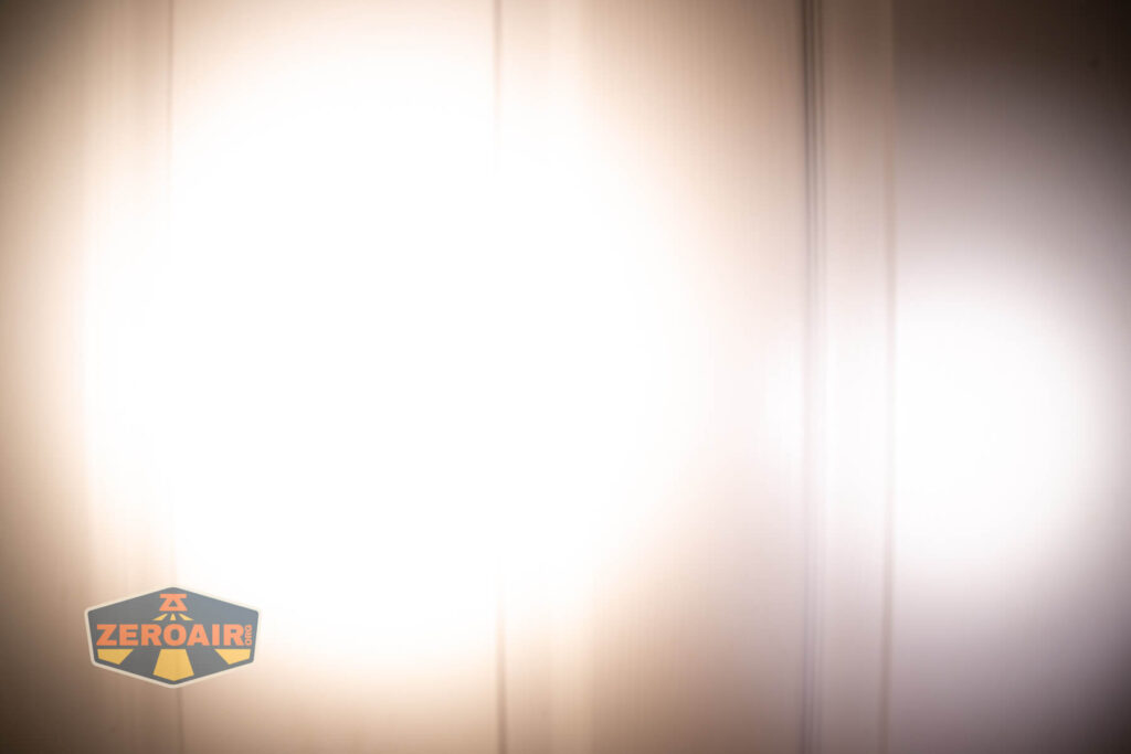 Emisar D3AA 5700K flashlight beamshots on door (at 1') compared to nichia 219b 4500K