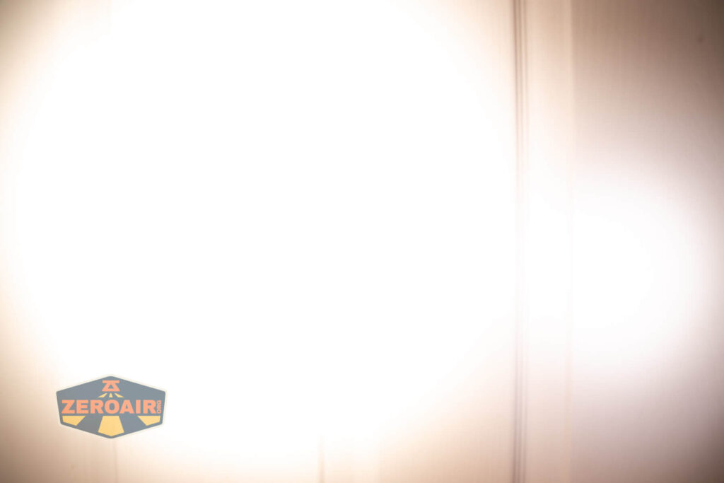 Emisar D3AA 5700K flashlight beamshots on door (at 1') compared to nichia 219b 4500K