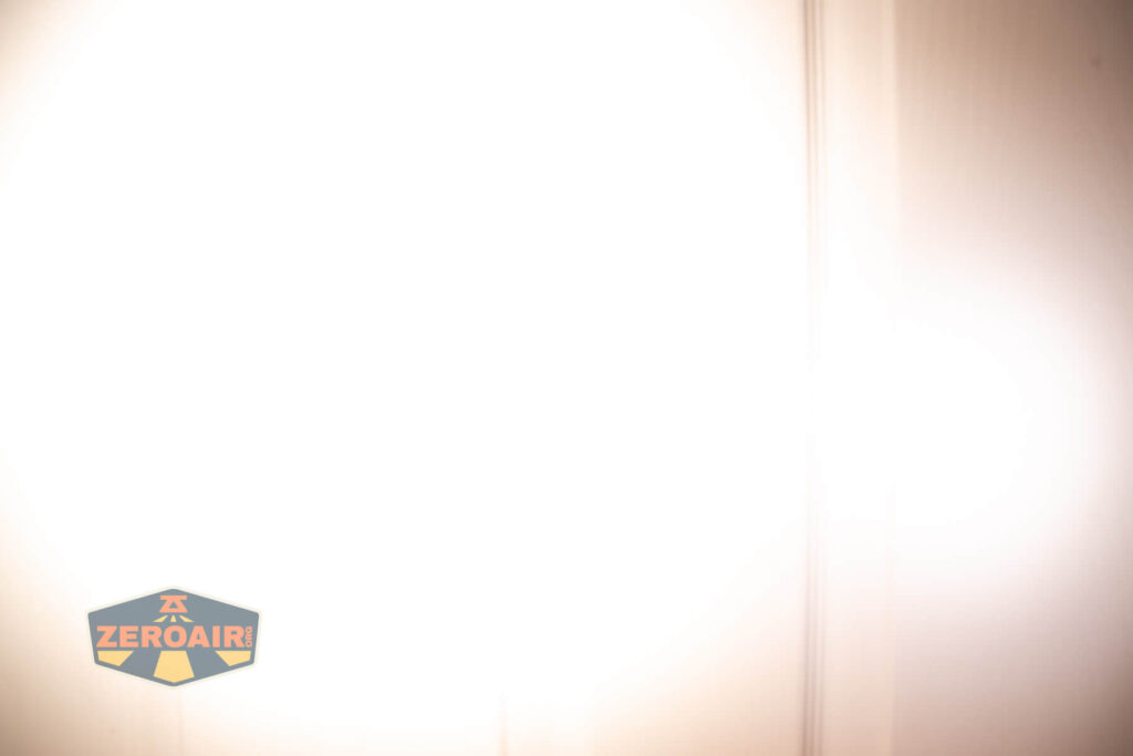 Emisar D3AA 5700K flashlight beamshots on door (at 1') compared to nichia 219b 4500K