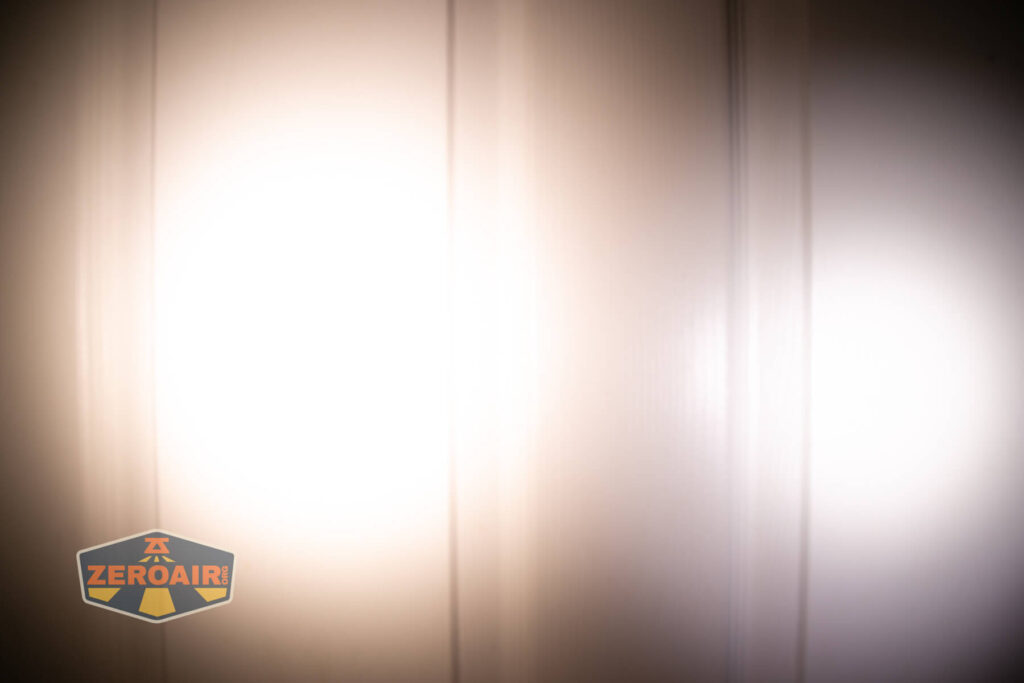 Emisar D3AA 5700K flashlight beamshots on door (at 1') compared to nichia 219b 4500K