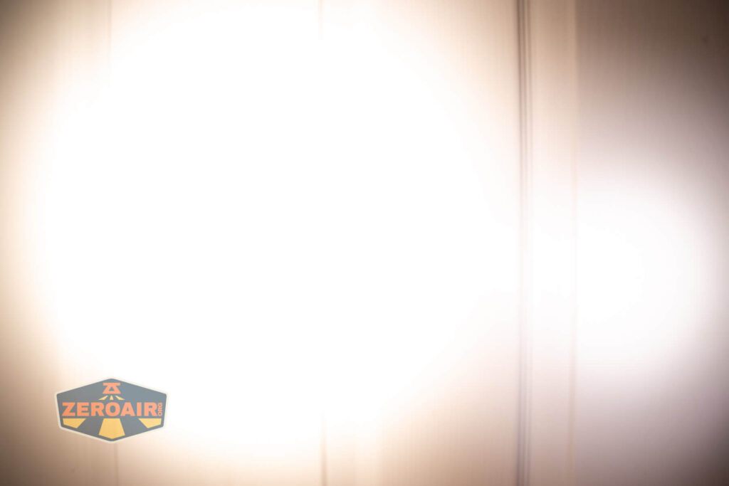 Emisar D3AA 5700K flashlight beamshots on door (at 1') compared to nichia 219b 4500K