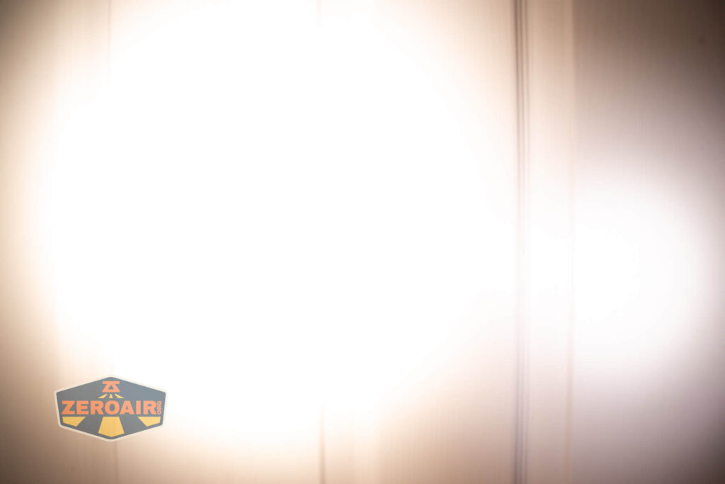 Emisar D3AA 5700K flashlight beamshots on door (at 1') compared to nichia 219b 4500K