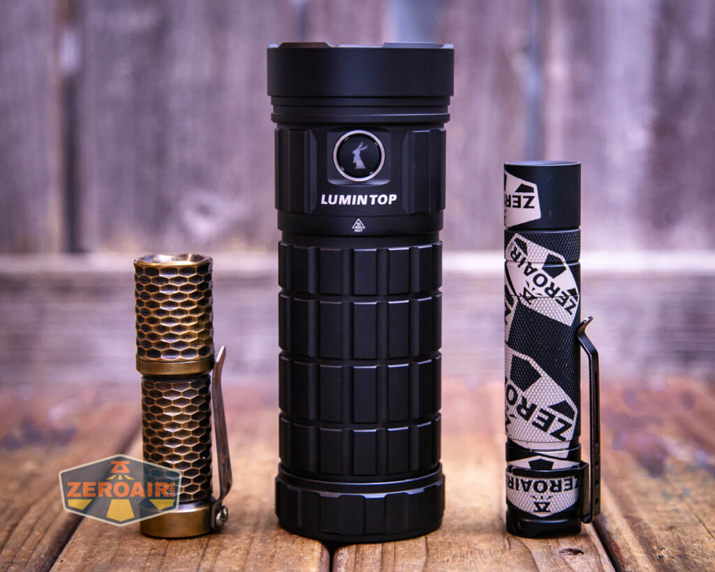 Lumintop GT18 flashlight with two standard sized flashlights