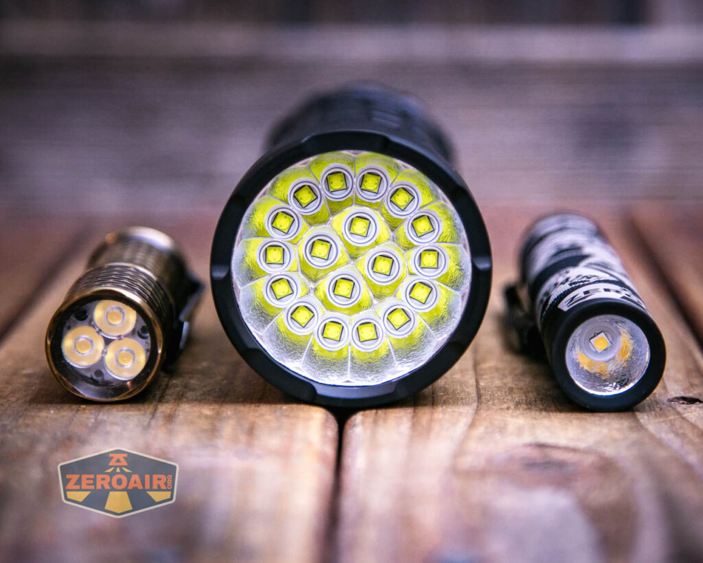 Lumintop GT18 flashlight with two standard sized flashlights