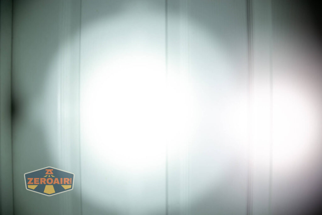 Sofirn SR15 rechargeable flashlight beamshots on door (at 1') compared to nichia 219b 4500K