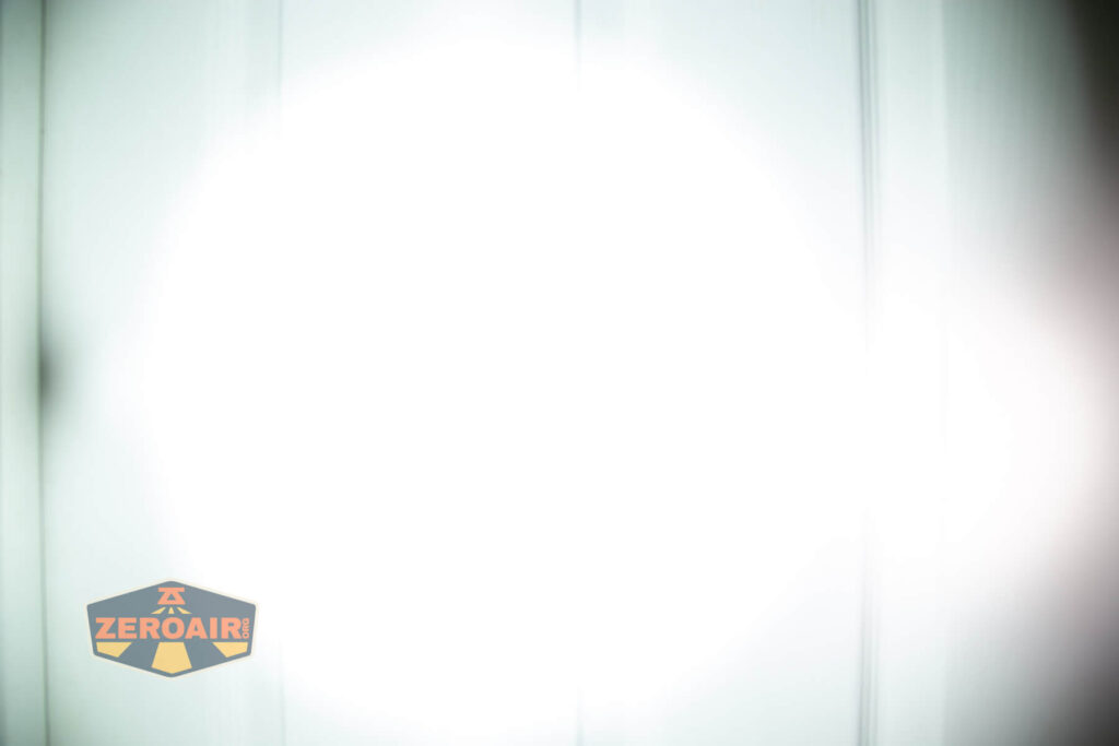 Sofirn SR15 rechargeable flashlight beamshots on door (at 1') compared to nichia 219b 4500K