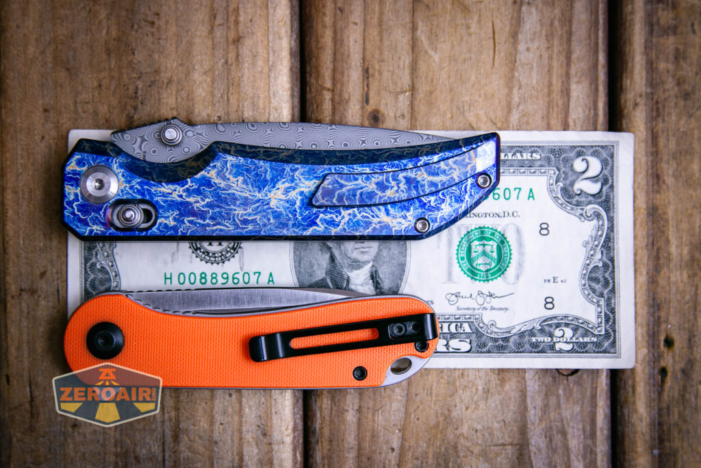 Kansept Eaglestrike knife on a two dollar bill compared to Civivi Elementum in orange