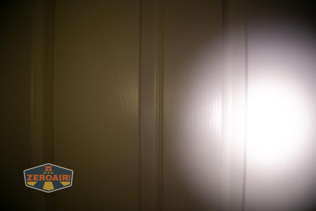 Wuben X4 flashlight beamshots on door (at 1') compared to nichia 219b 4500K