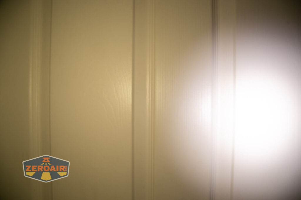 Wuben X4 flashlight beamshots on door (at 1') compared to nichia 219b 4500K