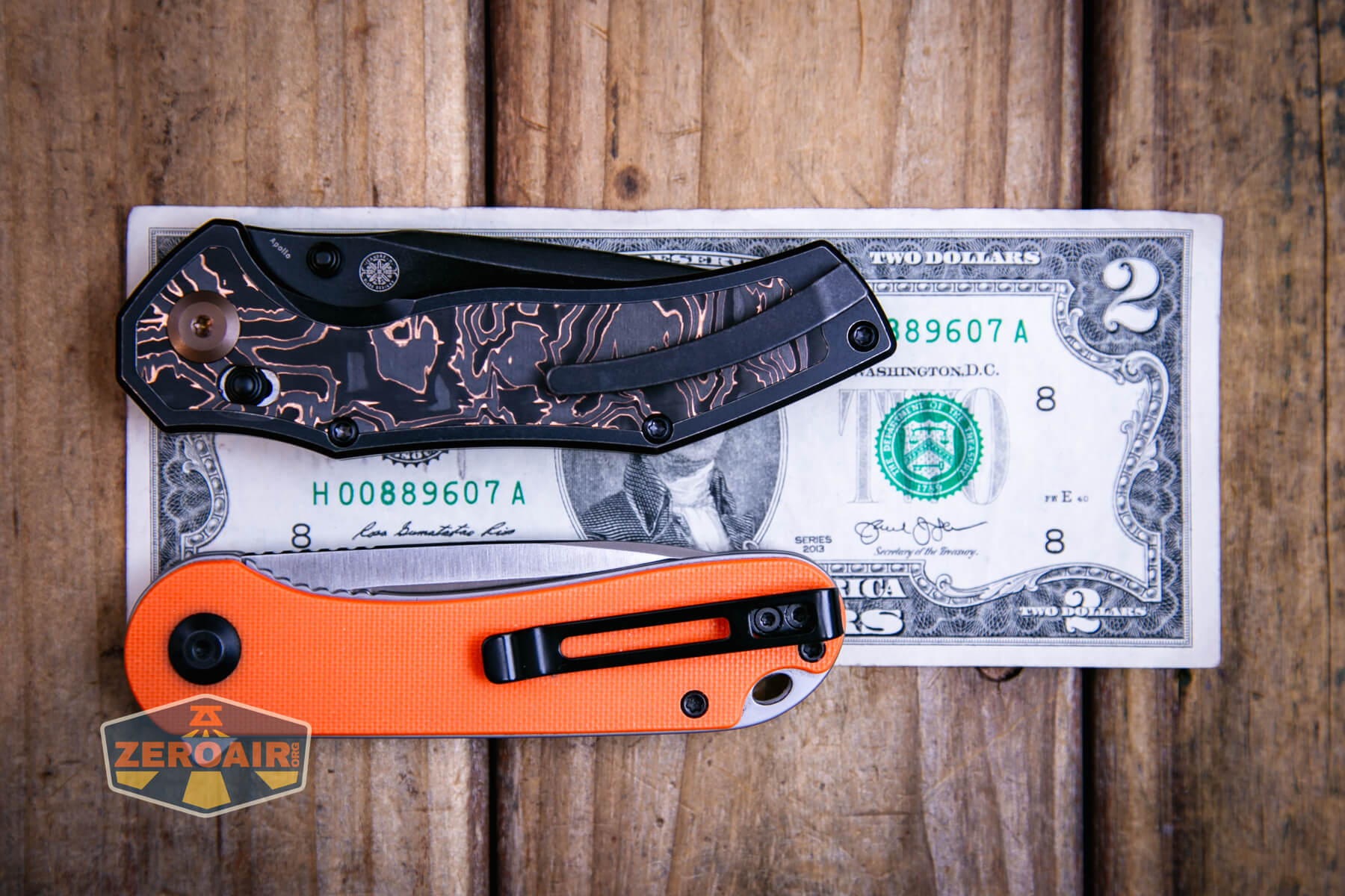 Kansept Apollo cross bar lock knife on a two dollar bill compared to Civivi Elementum in orange