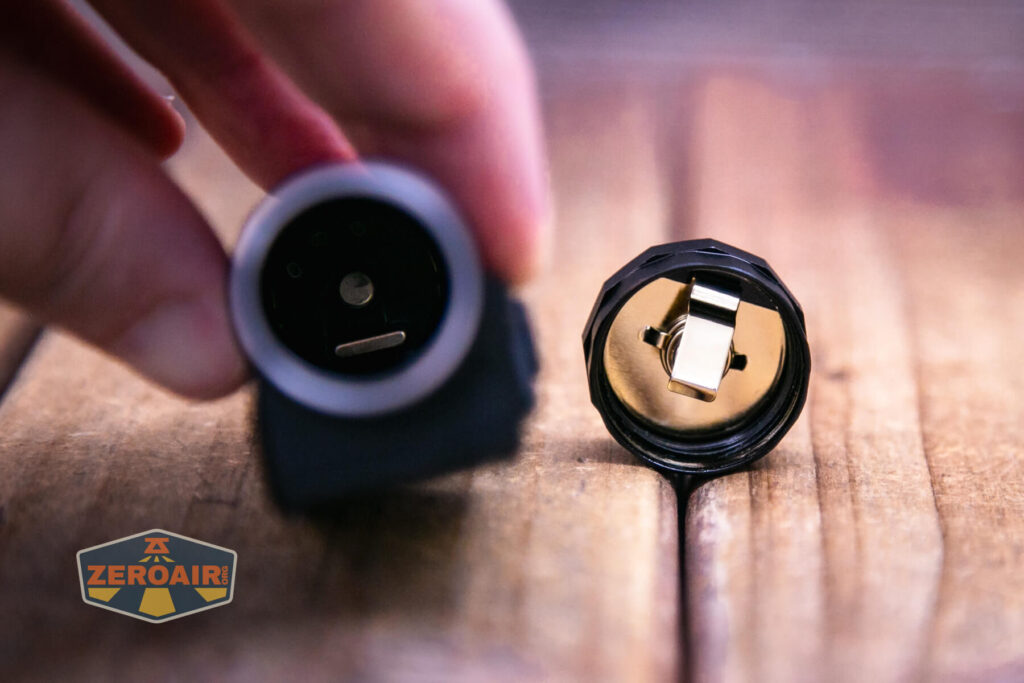 Nitecore HC65 UHE headlamp showing positive contact inside cell tube