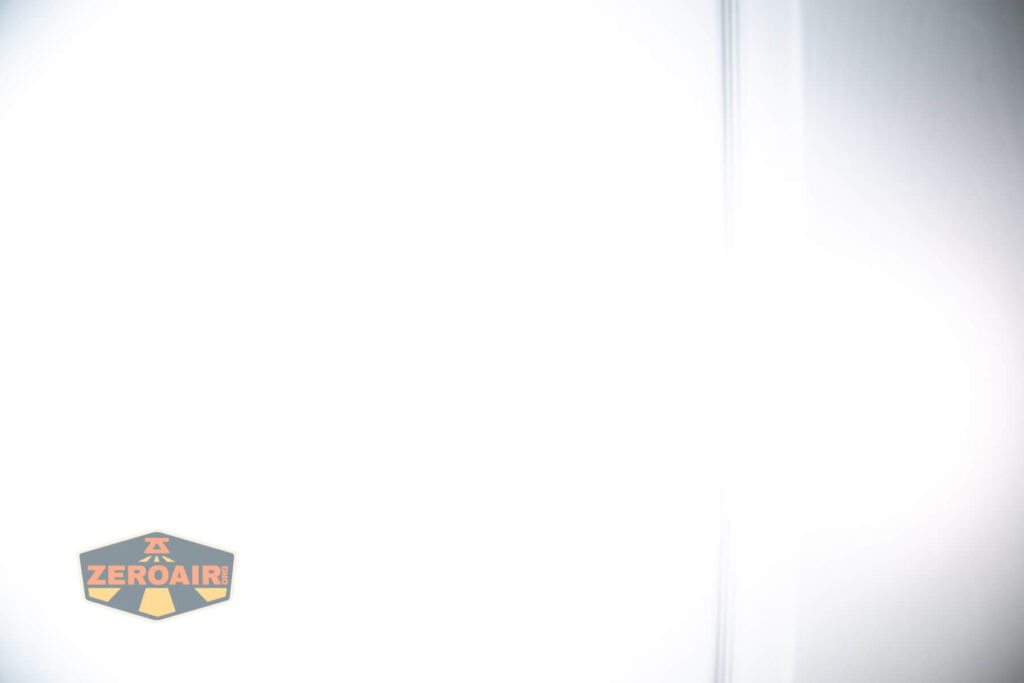 Nitecore HC65 UHE headlamp beamshots on door (at 1') compared to nichia 219b 4500K