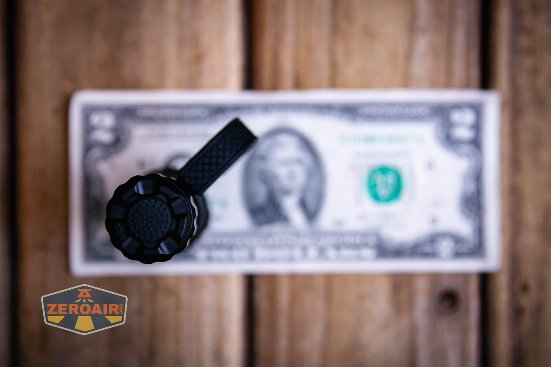 Wurkkos TD07 tactical flashlight on a two dollar bill