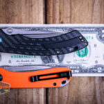 Kansept Pretatout flipper knife on a two dollar bill compared to Civivi Elementum in orange