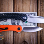 Kansept Pretatout flipper knife on a two dollar bill compared to Civivi Elementum in orange