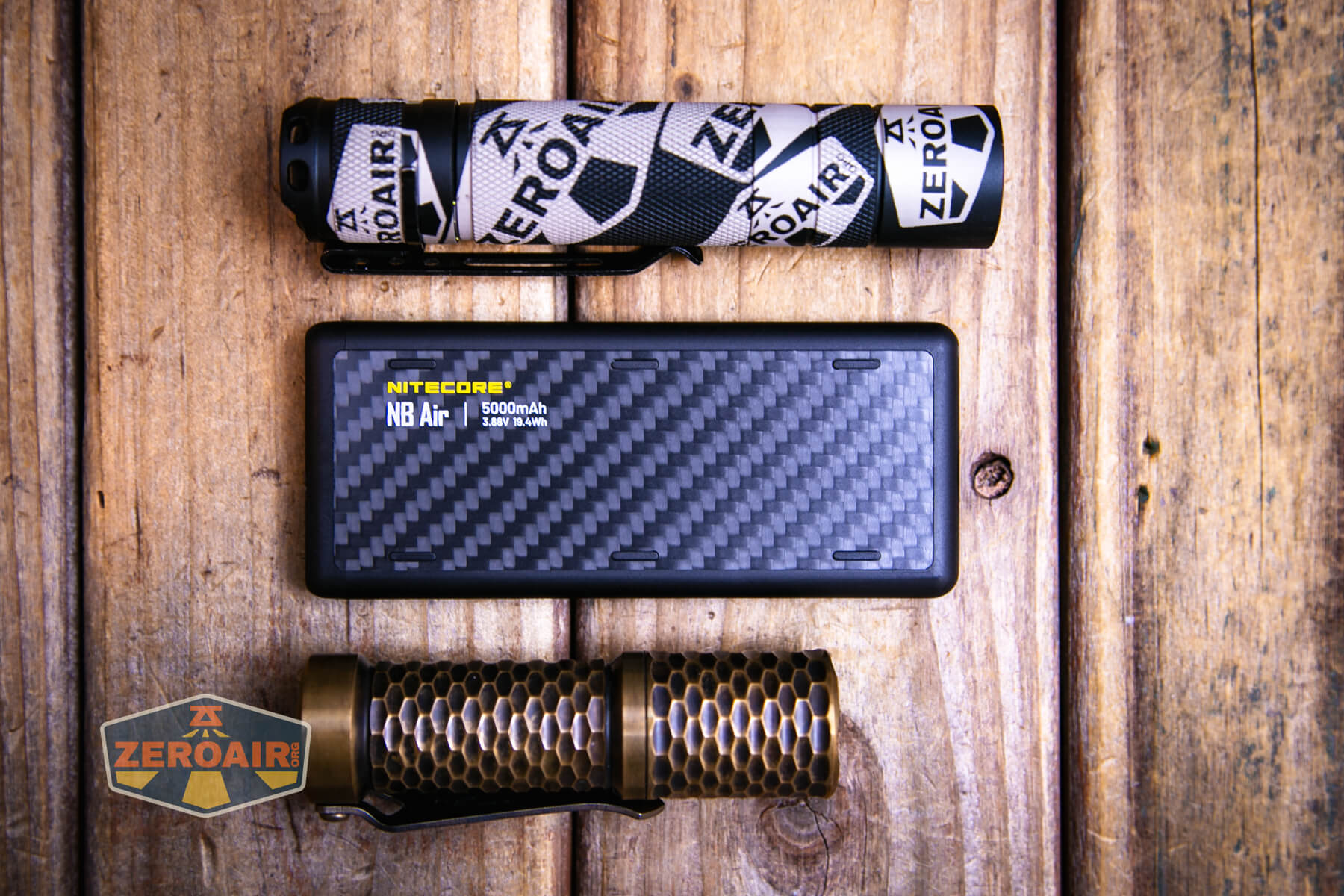 Nitecore NB Air power bank with two standard sized flashlights