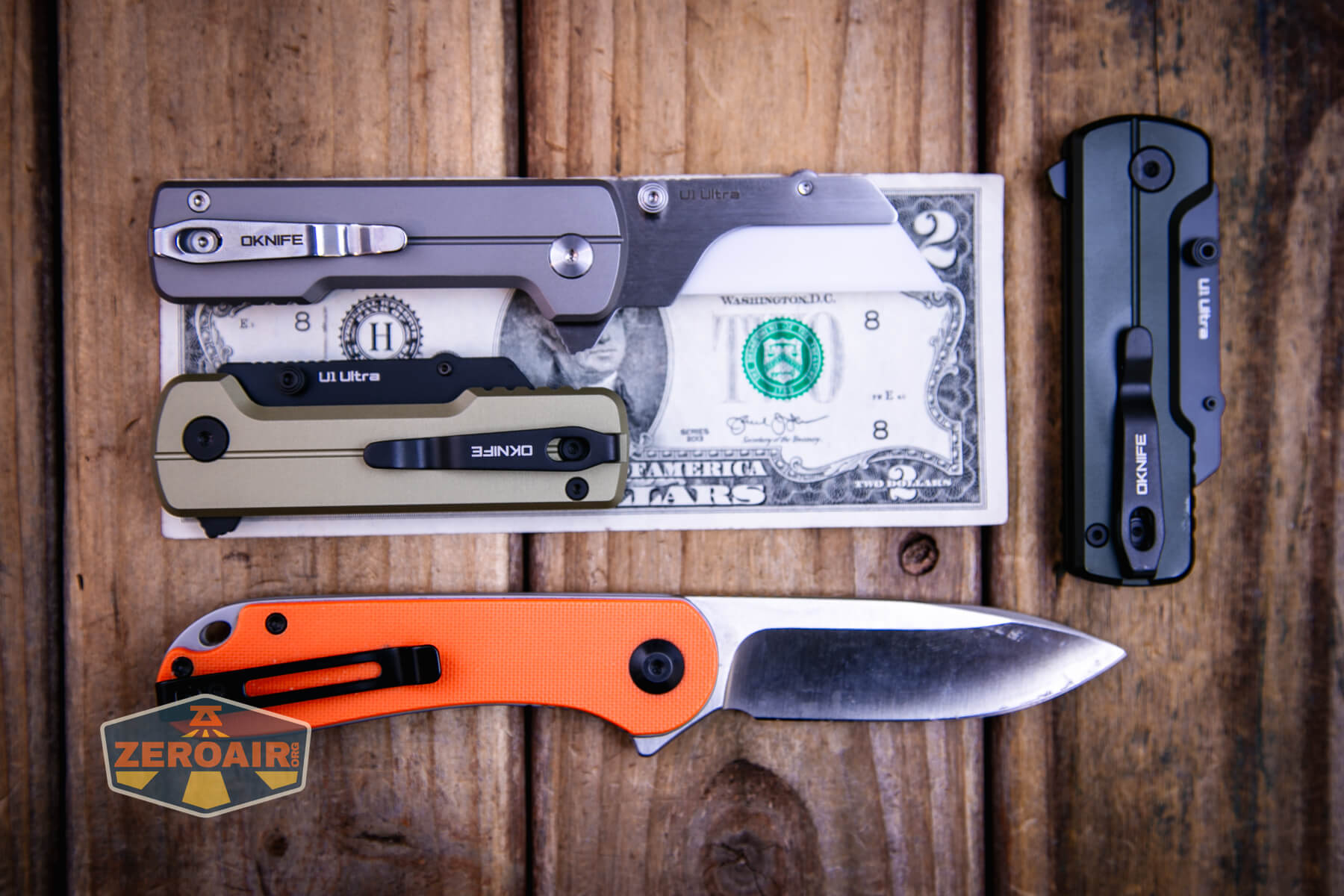Olight U1 Ultra utility knife on a two dollar bill compared to Civivi Elementum in orange