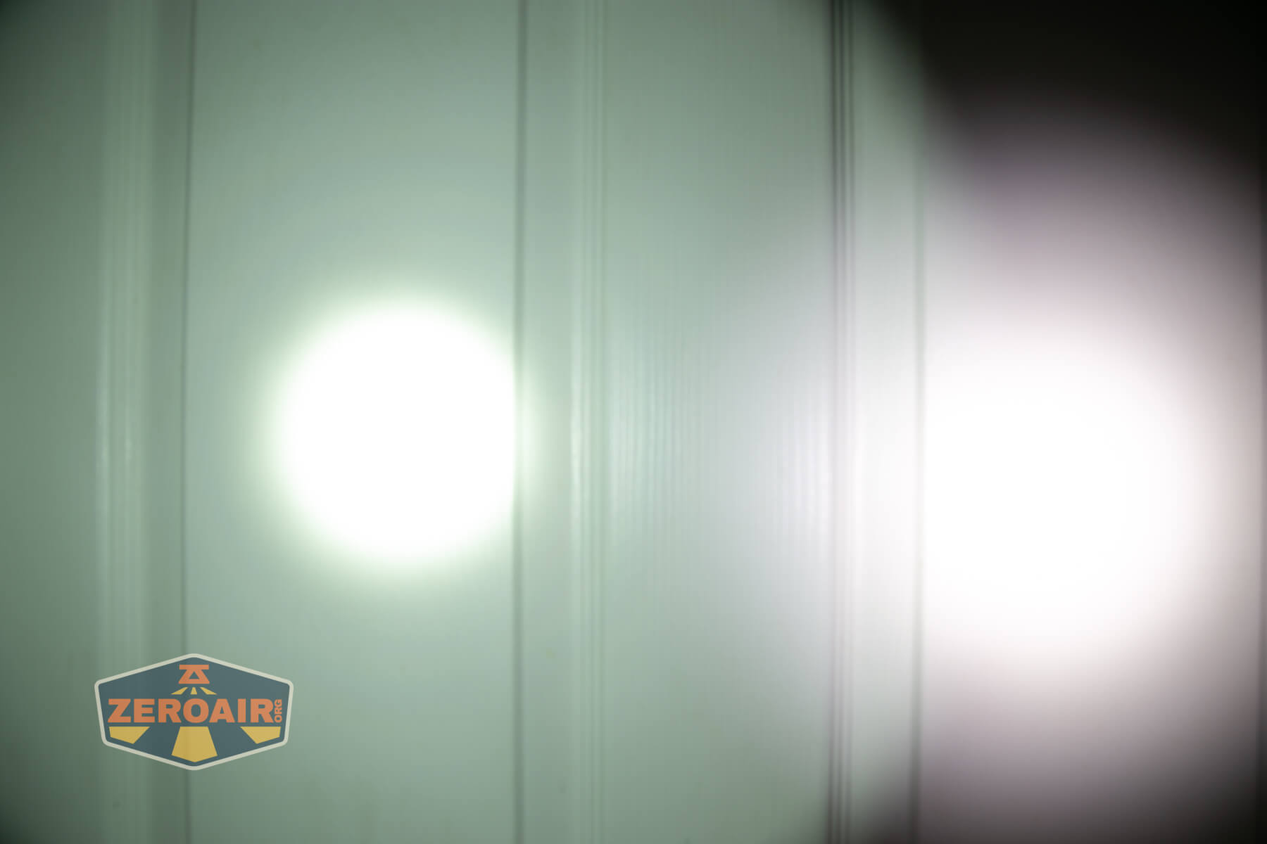 Skilhunt M150v4 Luminus SFT25R flashlight beamshots on door (at 1') compared to nichia 219b 4500K