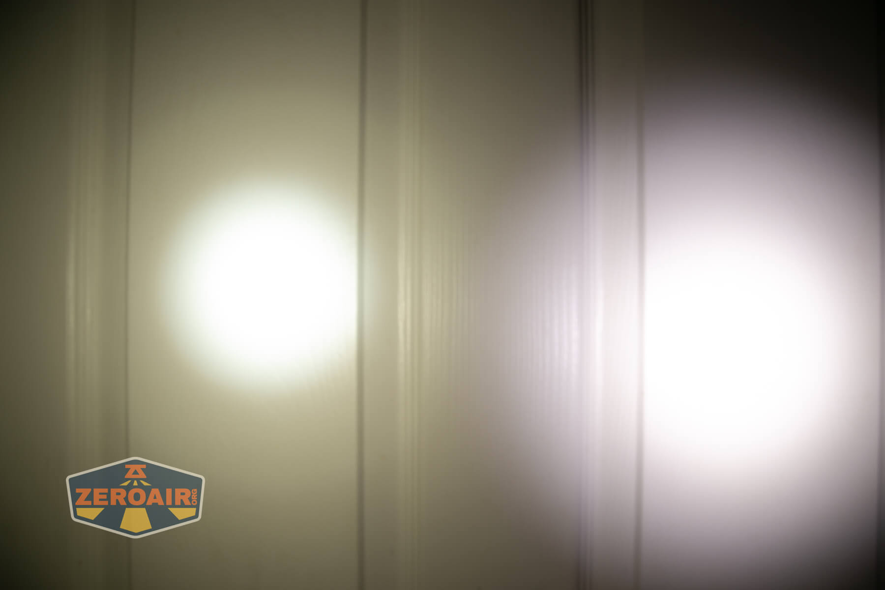 Sofirn HS22 headlamp beamshots on door (at 1') compared to nichia 219b 4500K