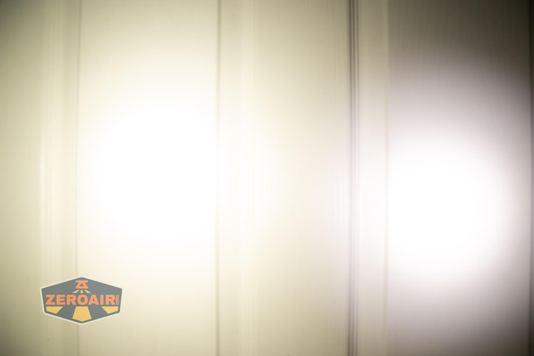 Sofirn HS22 headlamp beamshots on door (at 1') compared to nichia 219b 4500K