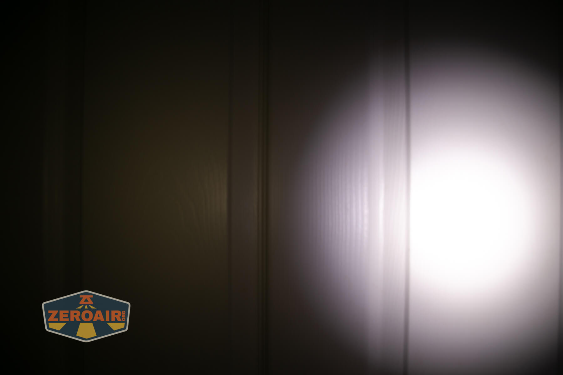 Sofirn HS22 headlamp beamshots on door (at 1') compared to nichia 219b 4500K