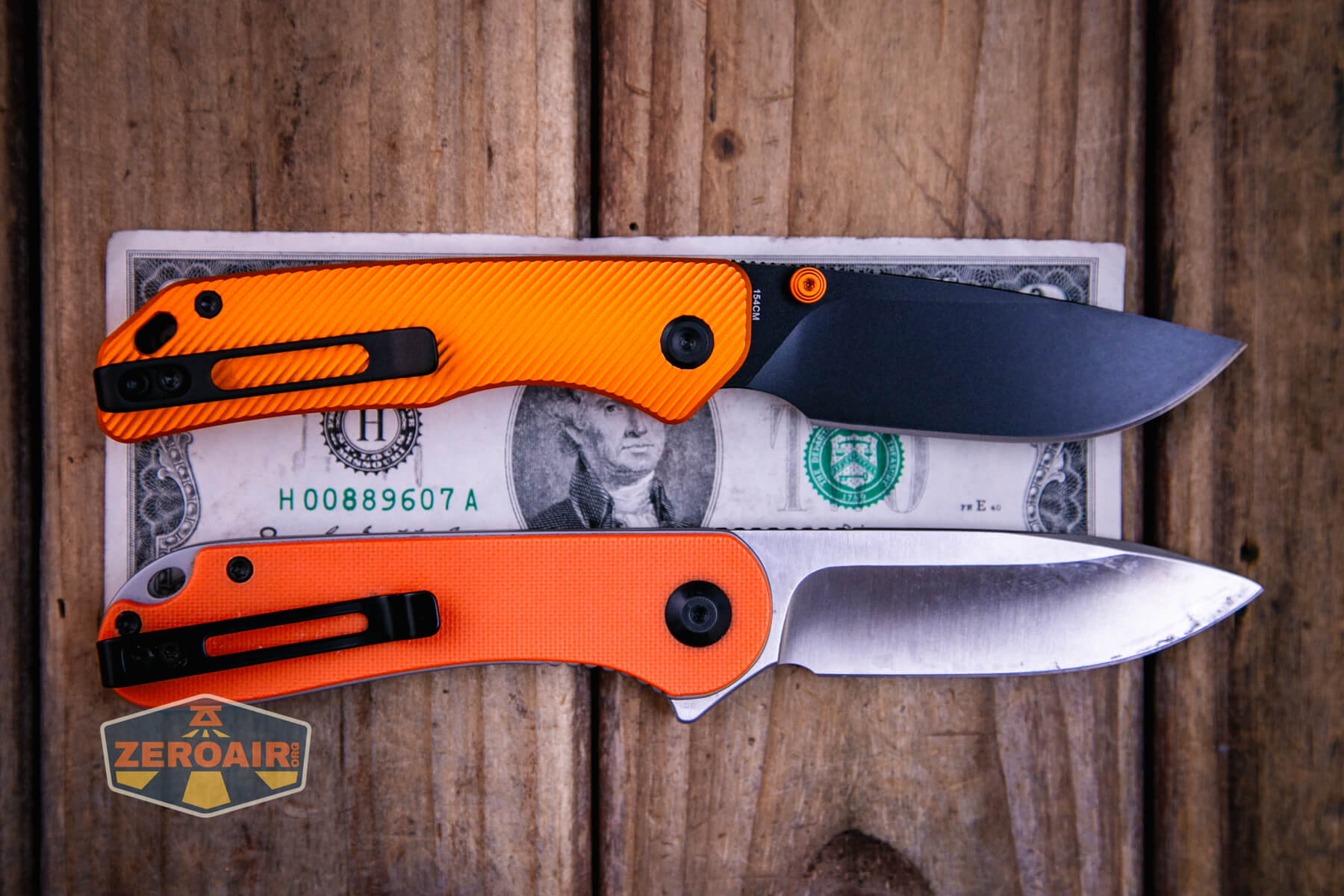 Vosteed Marten top liner lock knife on a two dollar bill with two standard sized flashlights