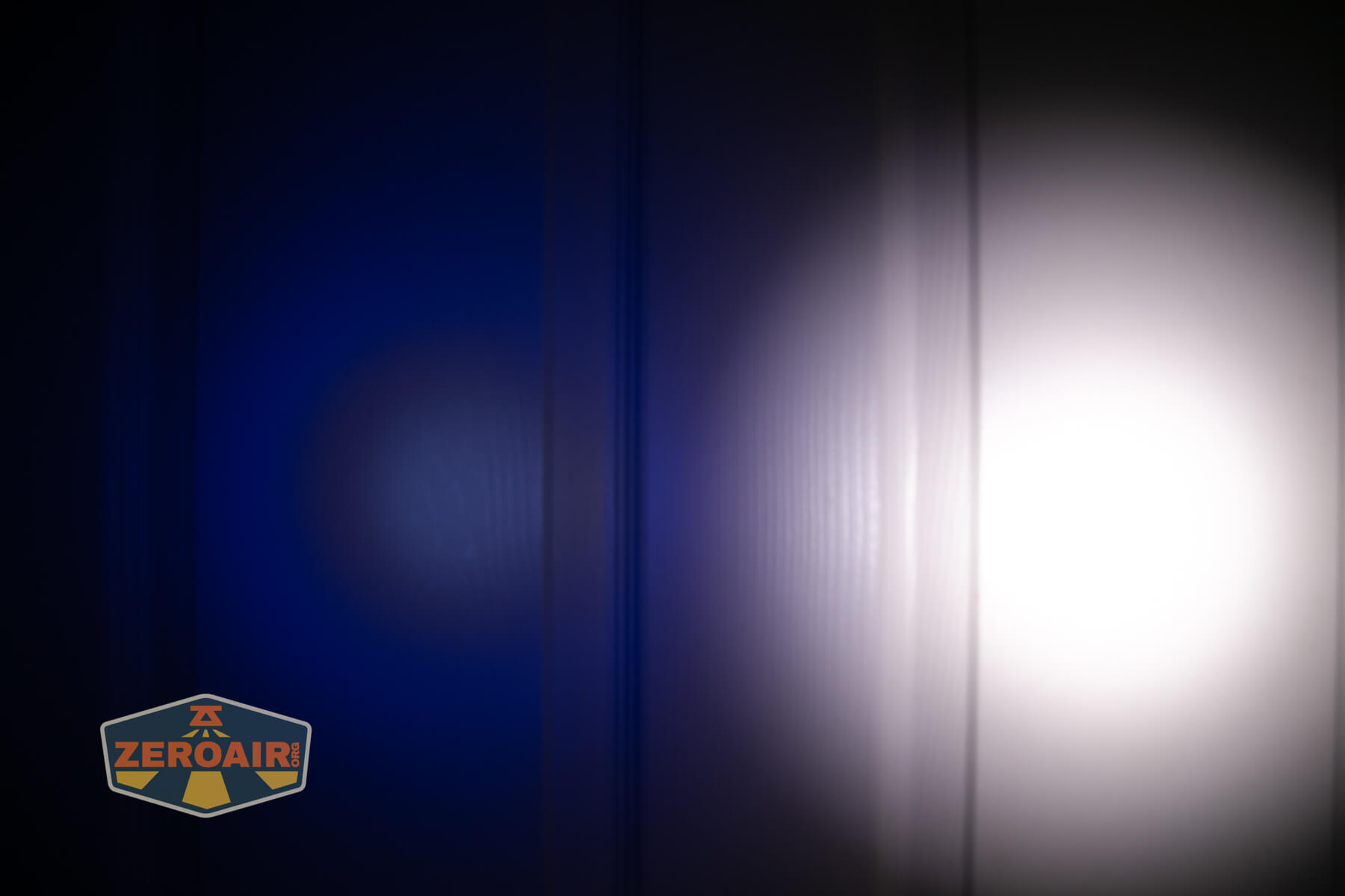 Wuben E8 modular flashlight beamshots on door (at 1') compared to nichia 219b 4500K