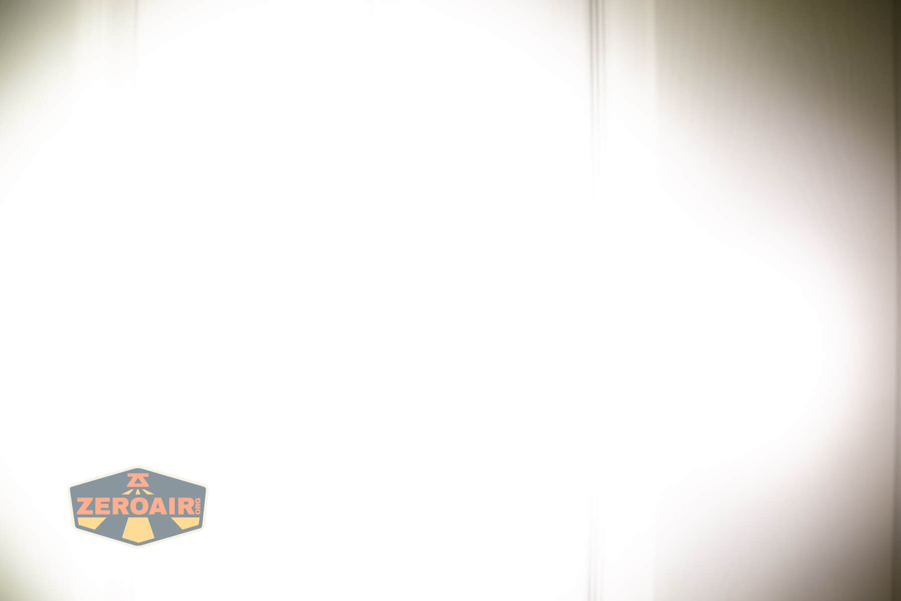 Wuben E8 modular flashlight beamshots on door (at 1') compared to nichia 219b 4500K