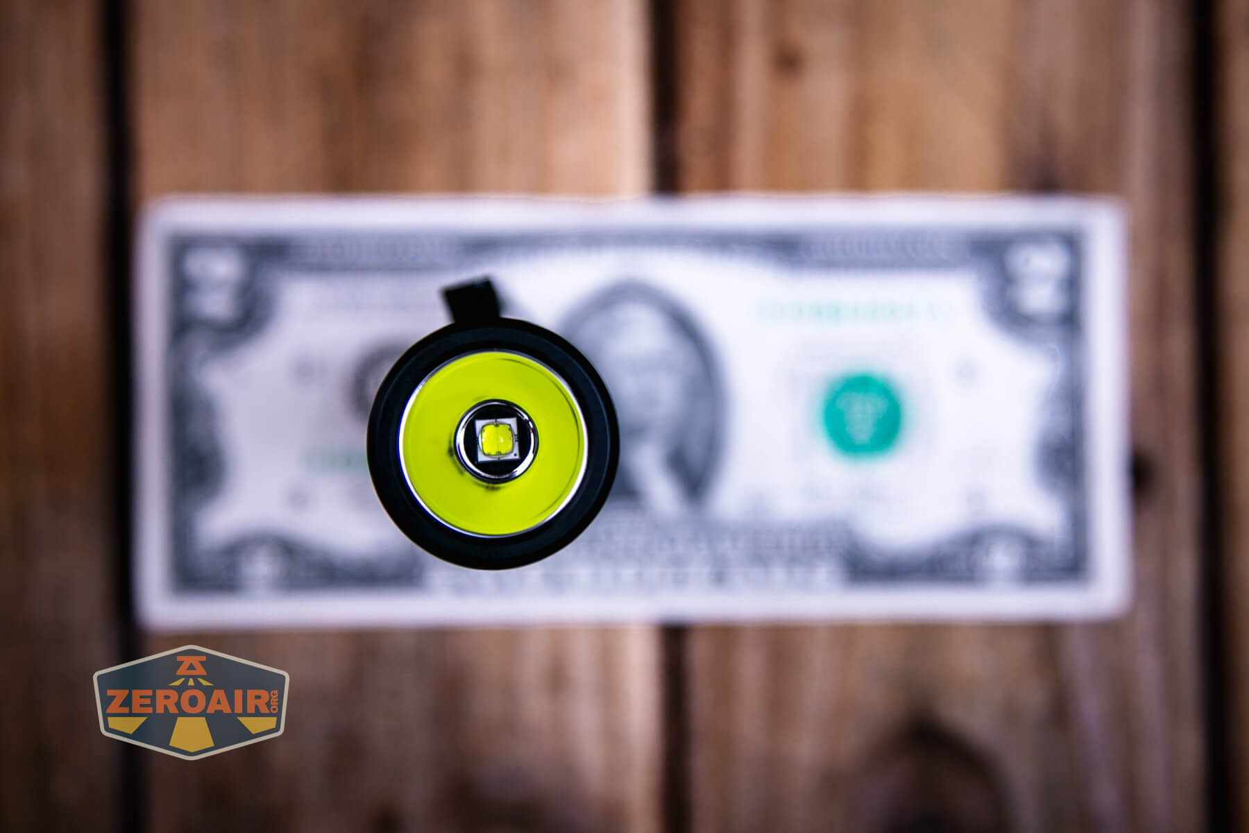 Wuben L3 flashlight on two dollar bill
