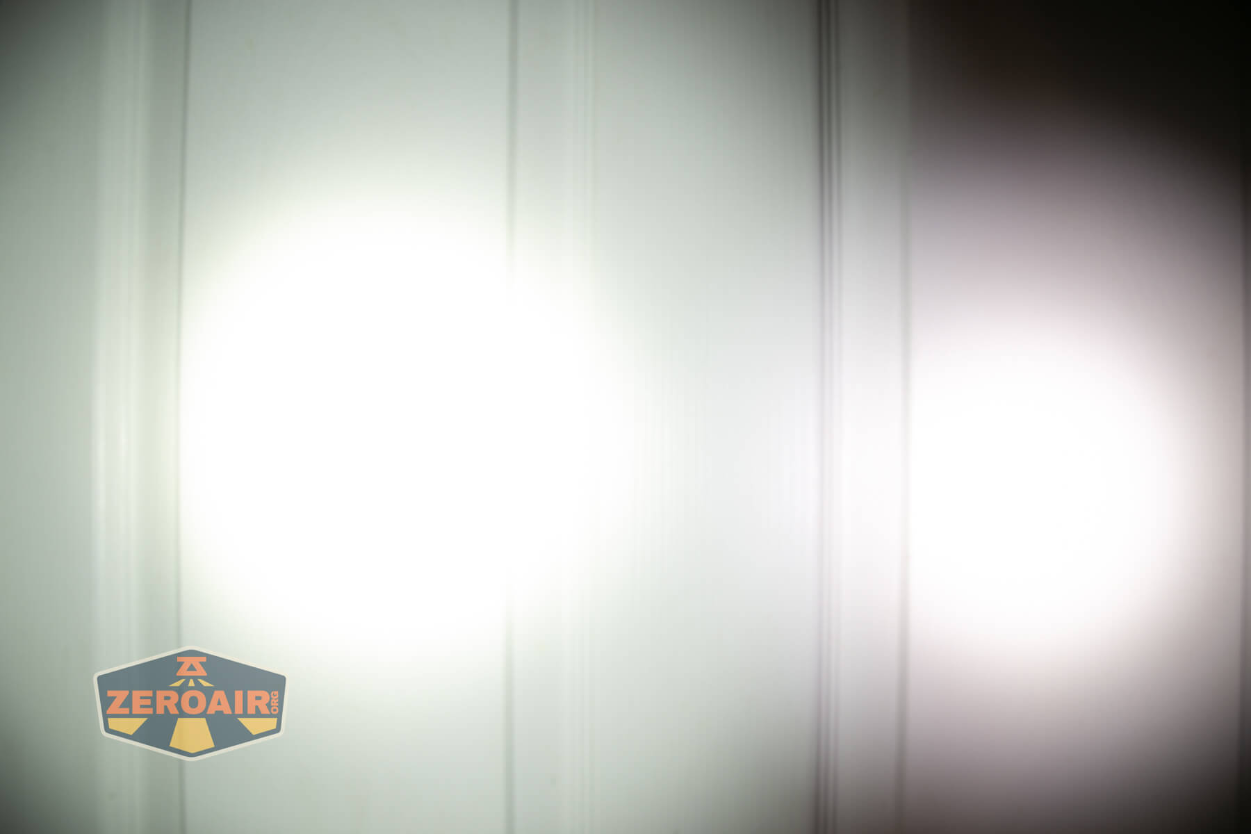 Wuben PL01 featherlight flashlight beamshots on door (at 1') compared to nichia 219b 4500K