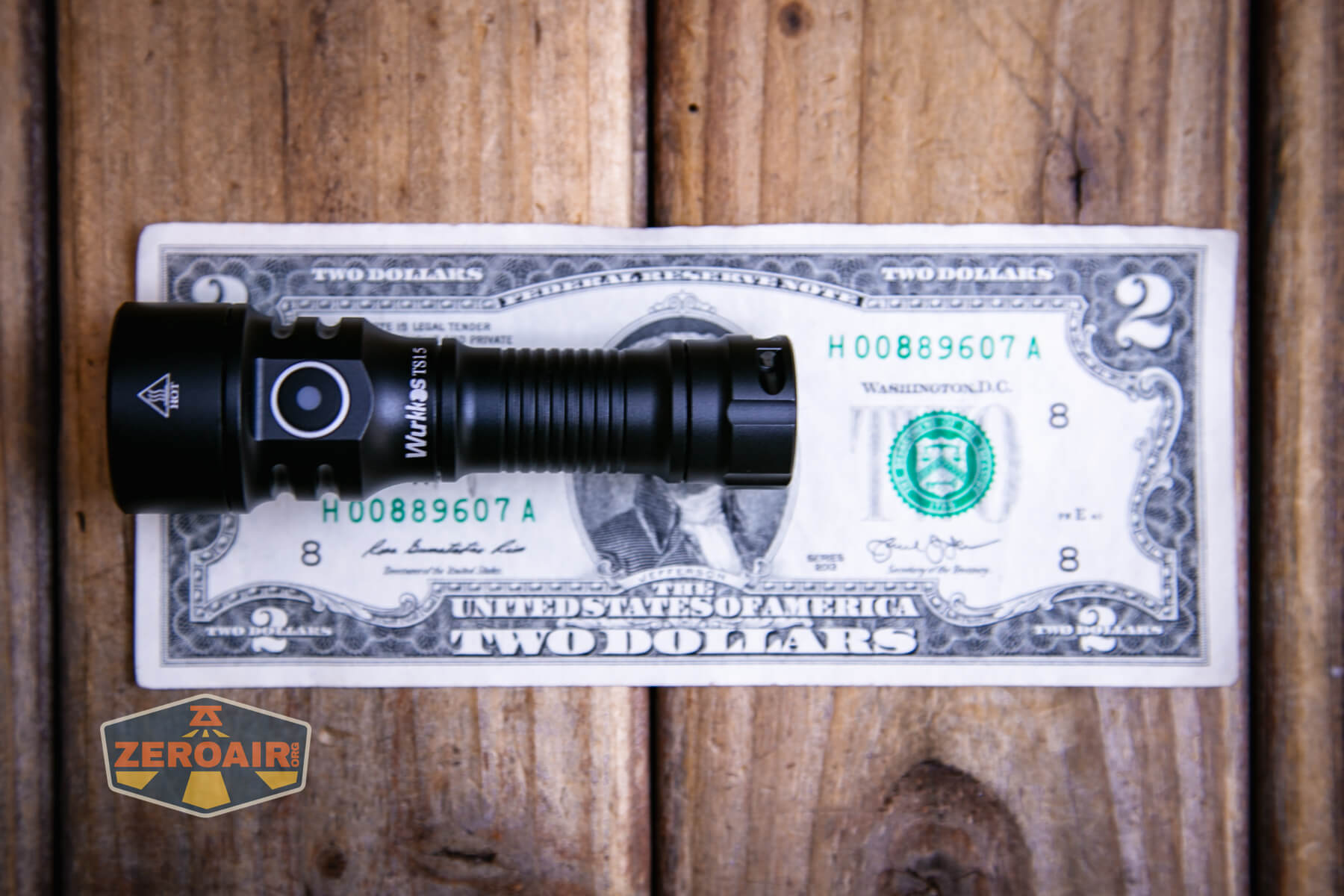 Wurkkos TS15 mini thrower flashlight on a two dollar bill