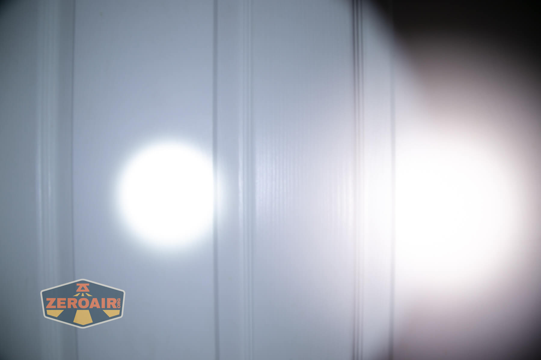 Wurkkos TS15 mini thrower flashlight beamshots on door (at 1') compared to nichia 219b 4500K