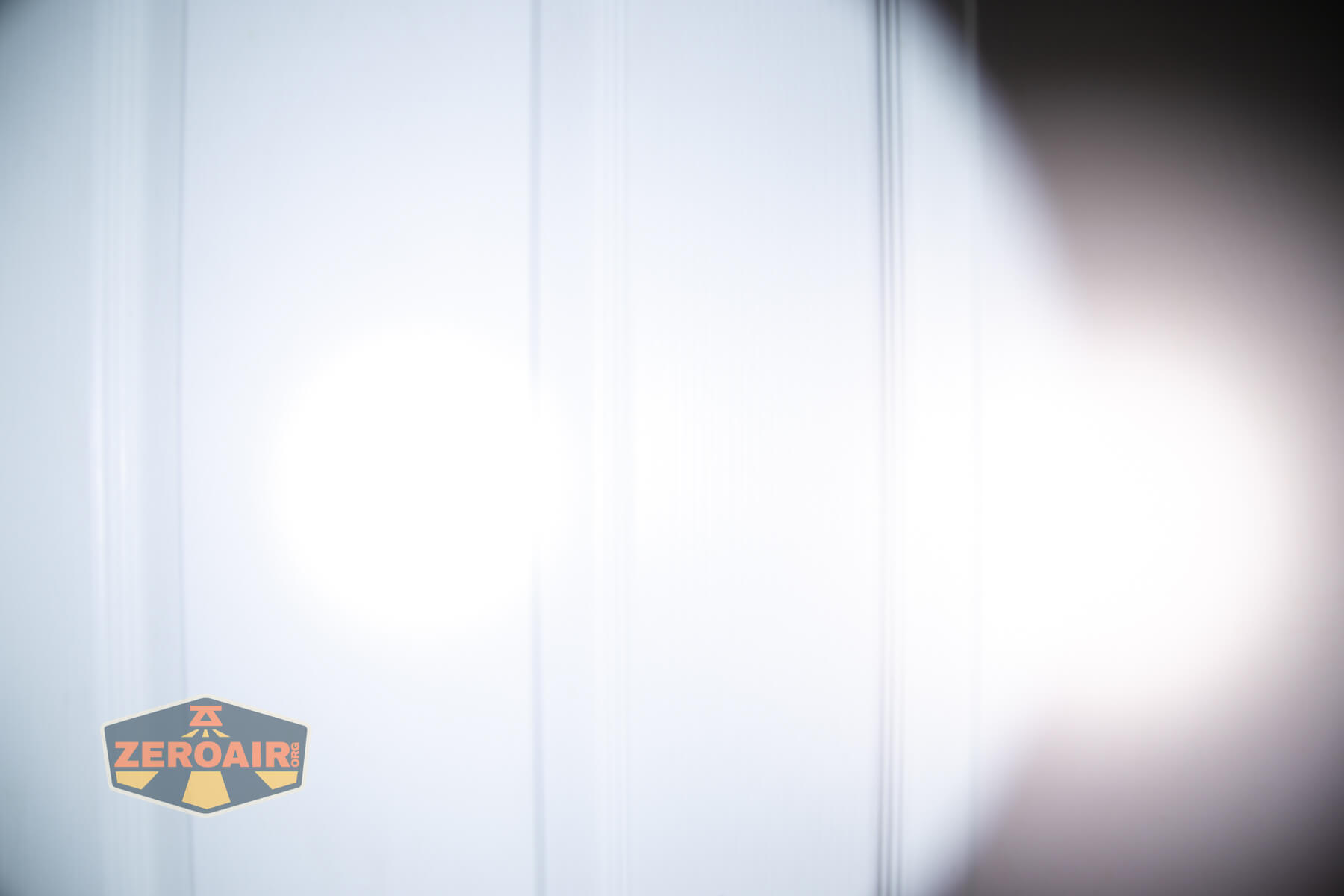 Wurkkos TS15 mini thrower flashlight beamshots on door (at 1') compared to nichia 219b 4500K