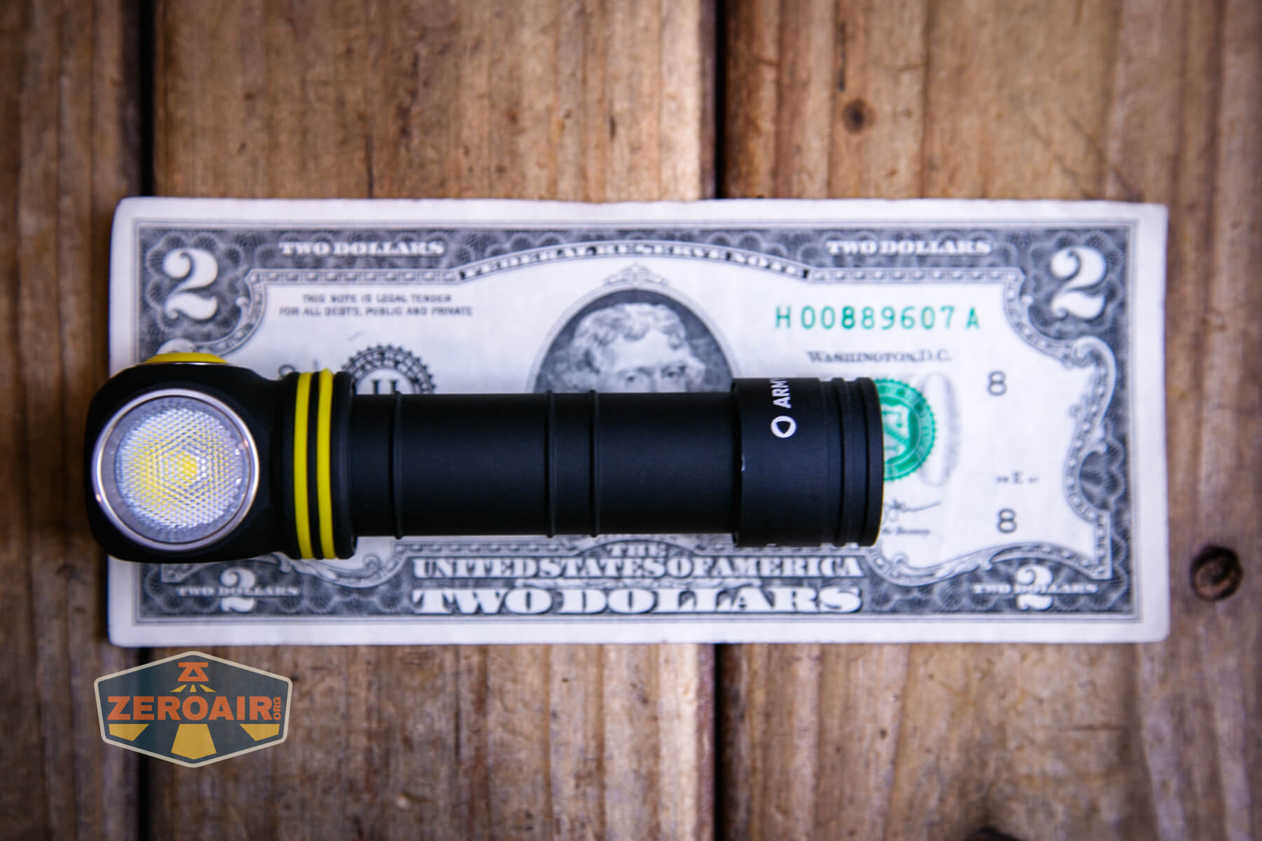 Armytek Elf C2 Warm headlamp on two dollar bill