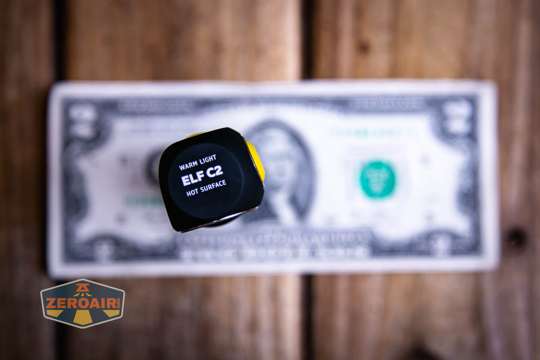 Armytek Elf C2 Warm headlamp on two dollar bill