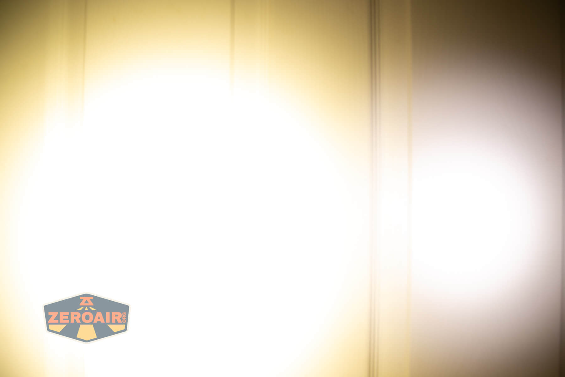 Armytek Elf C2 Warm headlamp beamshots on door compared to nichia 219b