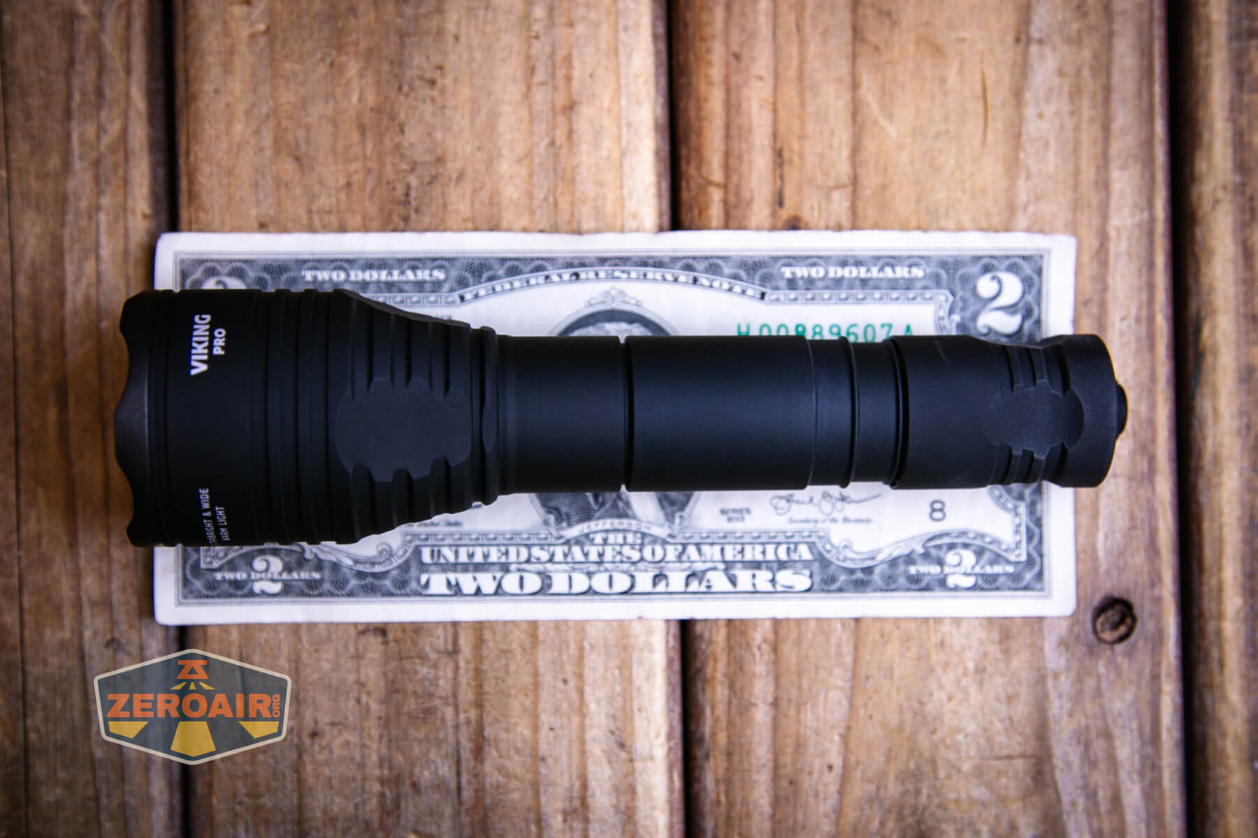 Armytek Viking Pro Magnet USB tactical flashlight on a two dollar bill